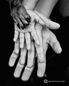 two hands reaching out towards each other with their fingers extended in black and white photo