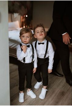 two young boys dressed in black and white tuxedos