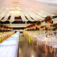 a banquet hall with tables and chairs set up for an event