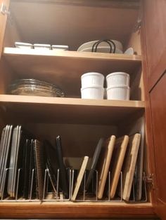 an open cabinet filled with lots of kitchen utensils