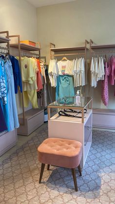 a small stool in front of a clothing rack