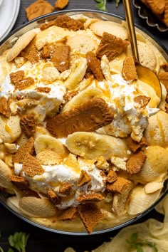 a bowl filled with bananas, cream and other toppings on top of a table