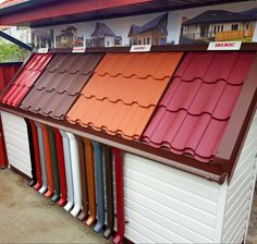 a row of different colored roof tiles on top of a building