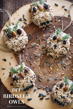 four birds made out of bird seed on a wooden platter with nuts and seeds