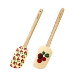 two wooden spoons with designs on them sitting next to each other in front of a white background