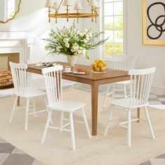 a dining room table with four chairs around it