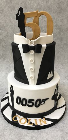 a 50th birthday cake decorated with the number fifty five in black, white and gold