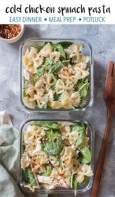 two plastic containers filled with pasta salad next to wooden utensils on a table