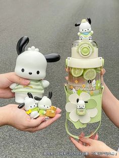 two people holding small toy animals in their hands