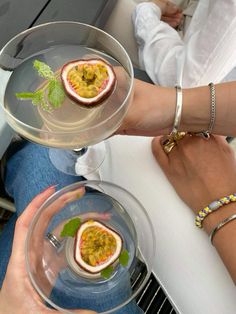 two people holding plates with food on them and one has a small piece of fruit in it