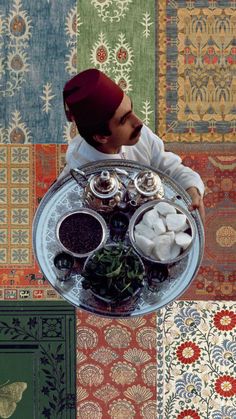 a man sitting at a table with food in front of him and looking up into the sky