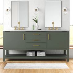 a bathroom with two sinks and mirrors on the wall