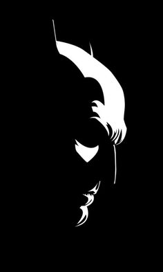 the batman logo is shown in black and white on a dark background, it appears to be an old man's face