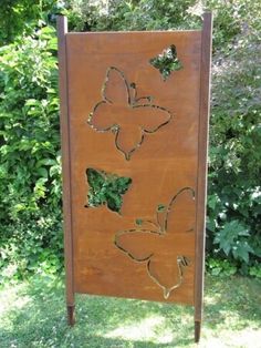 a wooden sign with three butterflies on it