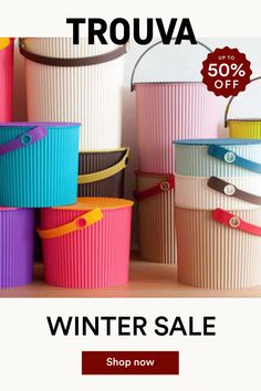 a group of colorful buckets sitting next to each other on a wooden table with the text trova summer sale up to 50 % off