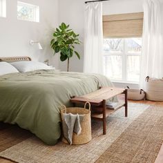 a bedroom with a large bed and green sheets