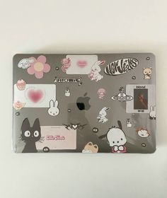 a laptop with many stickers on it