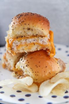 two cheeseburger sliders stacked on top of each other with potato chips in the foreground