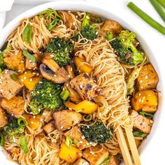 a bowl filled with noodles, broccoli and chicken