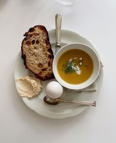 a white plate topped with soup and bread