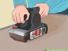 a person using a sander on the floor