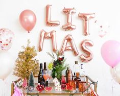 a table topped with lots of balloons and confetti next to a sign that says it's mas