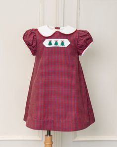 Made of 100% pima cotton. This classic dress is great for special occasions or church. Tab features Christmas trees on front and ladybugs on back. Once the holidays are over, you can reverse the tab and continue to wear. Sizes available: 2T-6. Short Sleeve Cotton Dress For Christmas, Festive Cotton Holiday Dress, Cotton Holiday Dress For Festive Occasions, Fitted Cotton Christmas Holiday Dress, Fitted Cotton Holiday Dress For Christmas, Festive Cotton Holiday Dress For Christmas, Fitted Cotton Christmas Dress, Cotton Holiday Dress, Short Sleeve Cotton Christmas Dress