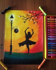 an art project with crayons and pastel pencils on a wooden table