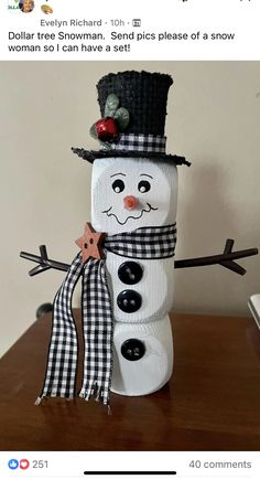 a snowman made out of toilet paper on top of a table