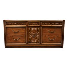 a wooden dresser with ornate carvings on the top and bottom drawers, against a white background