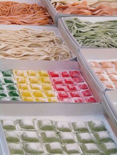 different types of noodles are displayed in trays