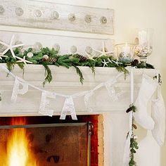 a fireplace decorated for christmas with stockings and garland