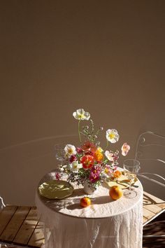 a table with flowers and plates on it