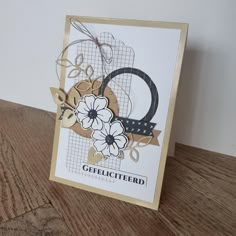 a close up of a greeting card on a wooden table with a wood floor and wall in the background