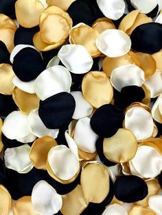 black, white and gold buttons are scattered on top of each other