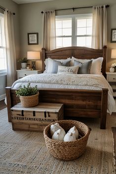 a large bed sitting in a bedroom next to two baskets filled with pillows and blankets