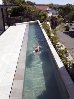 a person swimming in a pool on top of a building