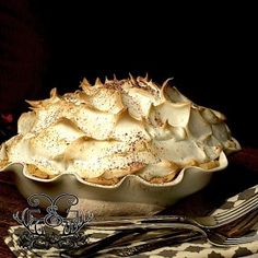 a pie sitting on top of a table next to a fork