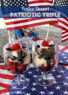 patriotic trifle with strawberries, raspberries and blueberries in glasses on an american flag tablecloth