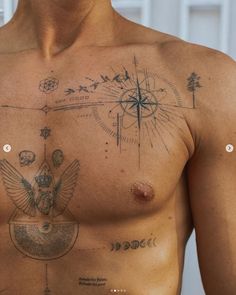 a man with tattoos on his chest has an eagle and compass tattoo on his chest