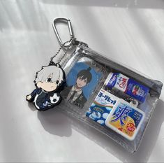 a keychain with an anime character and toothpaste in it on a white surface