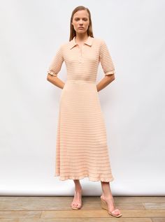 This long knit dress, made in Italy from pure extra-fine virgin wool, has a straight, flowing cut. Slightly held in at its narrow waistband, it features a knit inspired by origami folding. Its buttoned placket with mother-of-pearl buttons and polo collar contrast elegantly with the lightweight knit. In a fresh, summery “nude” color, wear this fine wool dress in summer with sandals and gold jewelry. the model is 1m78 tall and wears a size s. Long Knit Dress, Pull Bebe, Origami Folding, Long Knitted Dress, Long Knit, Nude Color, Wool Dress, Mother Of Pearl Buttons, Pearl Buttons