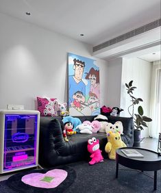 a living room filled with black furniture and lots of stuffed animals on top of it