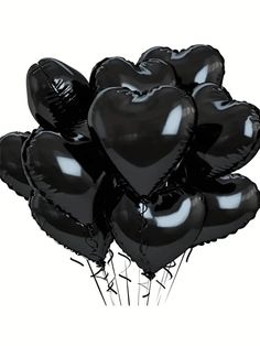 a bunch of black heart shaped balloons