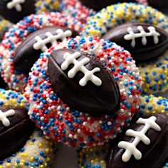 chocolate covered football cookies decorated with sprinkles