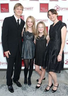 three people standing next to each other on a red carpet