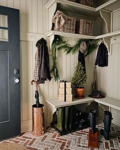 a coat rack with umbrellas, books and other items on it next to a door