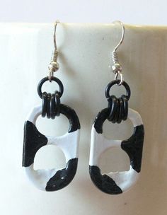 the black and white earrings are hanging from hooks