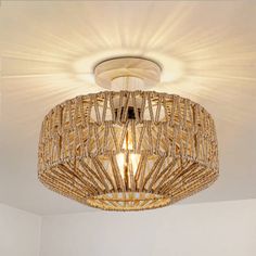 a chandelier hanging from the ceiling in a room with white walls and flooring