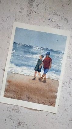 an old photo of two people walking on the beach